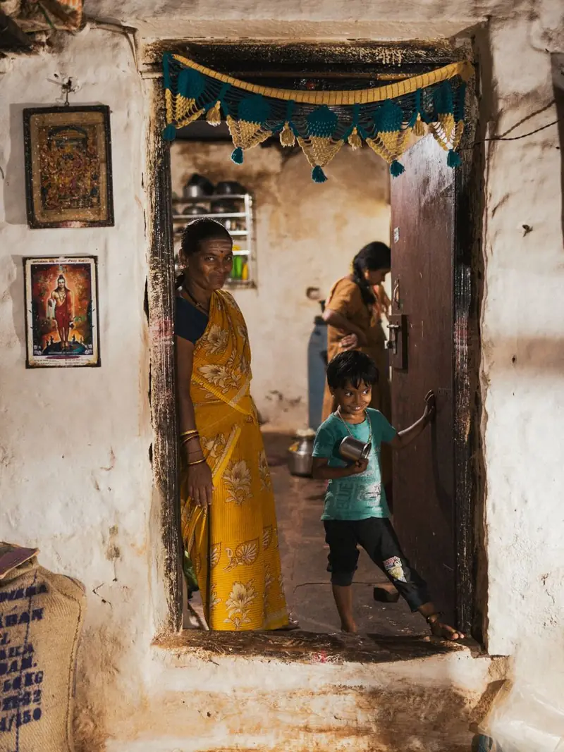 A family standing at the entrance of their home